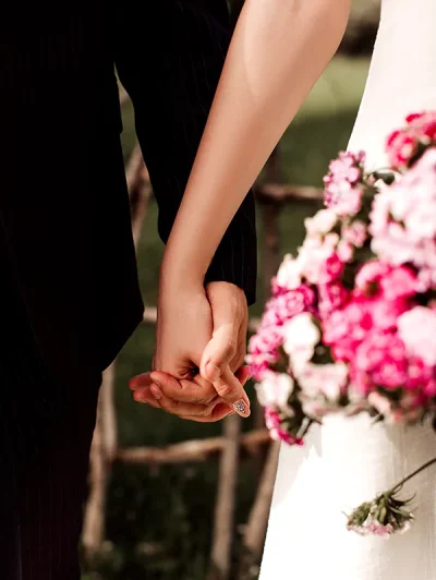 front-close-up-view-pair-loving-man-woman-holding-each-others-hands-wedding copy