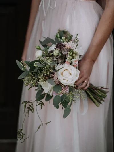 vertical-shot-bride-wearing-wedding-dress-holding-flower-bouquet copy
